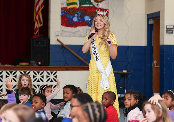 Miss Virginia speaks to gathering of Yates Elementary students