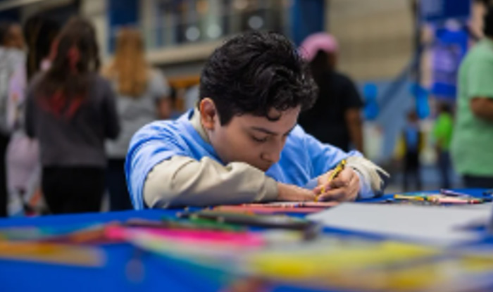 Young male student working on a craft.